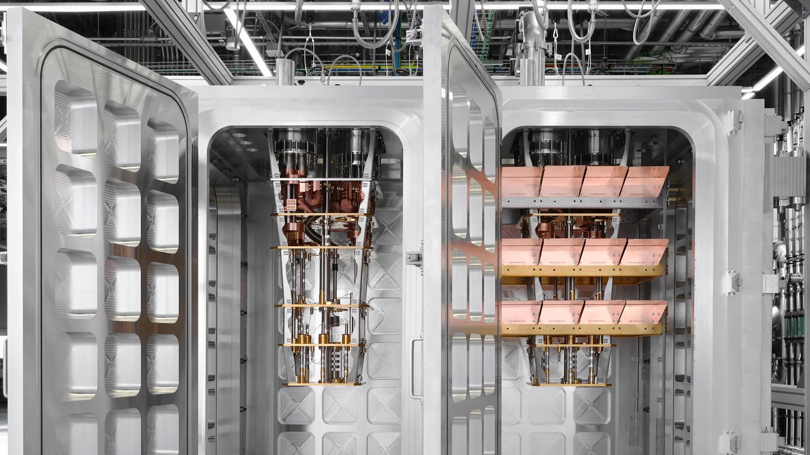 IBM's photograph of the two connected cryogenic modules with their doors open, showing both gold-and-copper cooling assemblies suspended inside quilted steel enclosures, joined through the shared frame