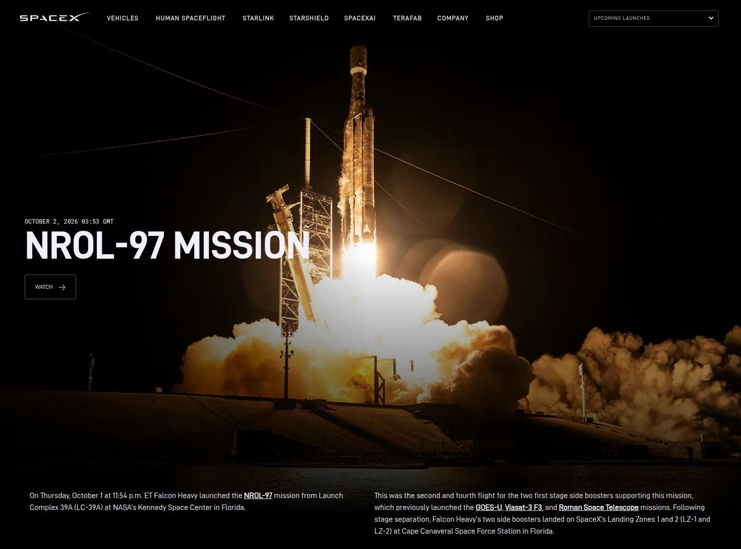 SpaceX's NROL-97 mission page: a night photograph of Falcon Heavy rising from pad 39A on a column of flame above a bank of orange exhaust cloud, the launch tower to its left, under the heading NROL-97 Mission. Below the photograph, SpaceX's text says Falcon Heavy launched NROL-97 at 11:54 p.m. ET on Thursday 1 October from Launch Complex 39A, that the side boosters were on their second and fourth flights after GOES-U, ViaSat-3 F3 and the Roman Space Telescope, and that both landed on Landing Zones 1 and 2.
