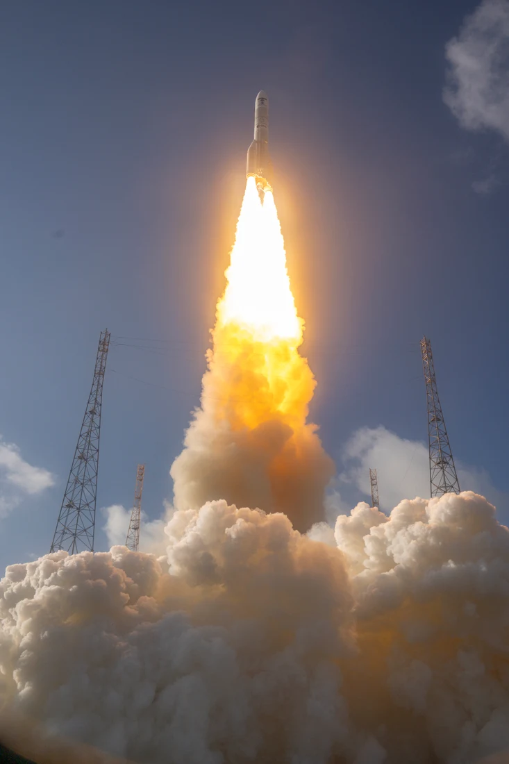 Ariane 6 lifting off with a bright exhaust plume.