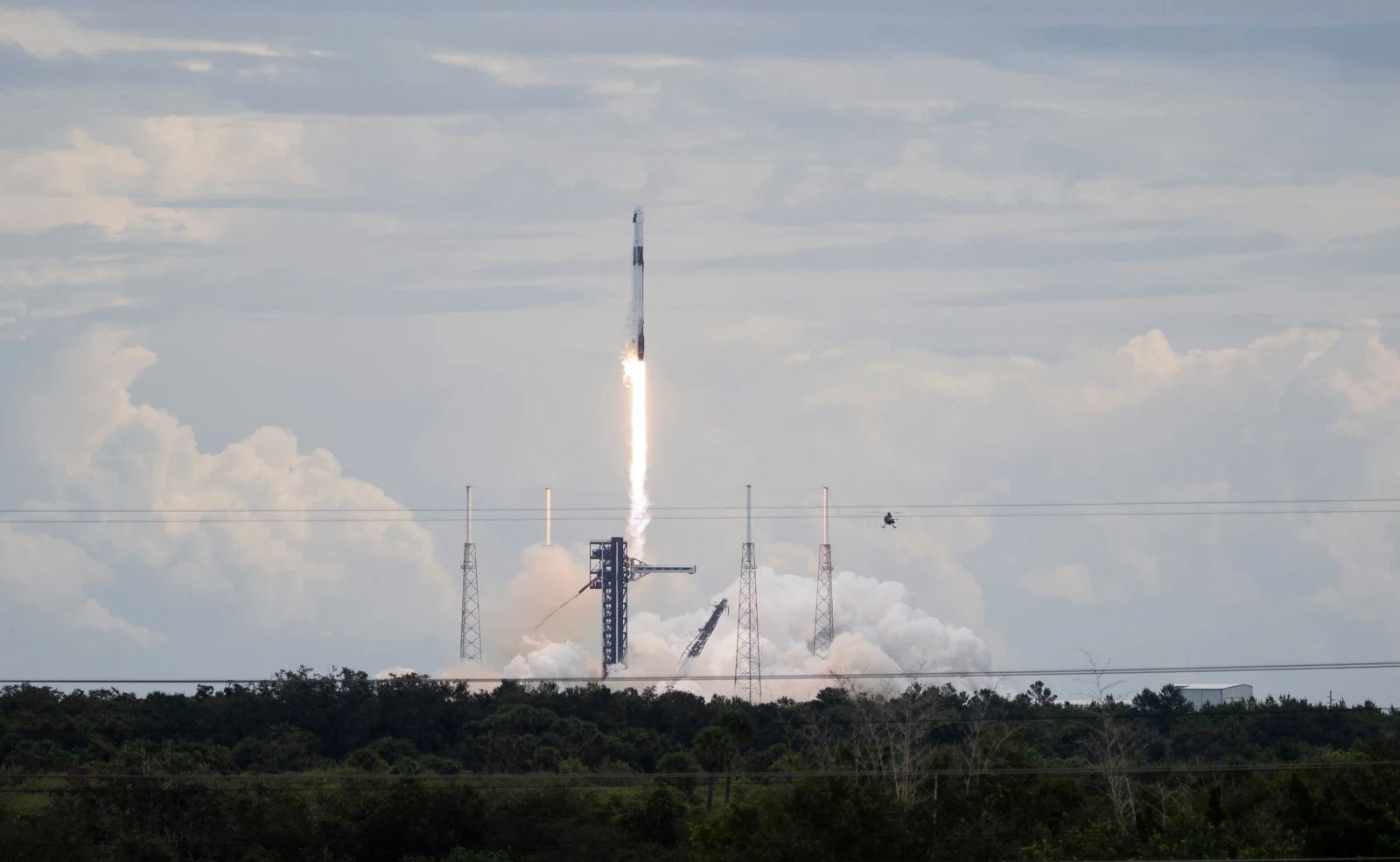 A Falcon 9 carrying Dragon lifts off during the earlier Crew-13 mission.