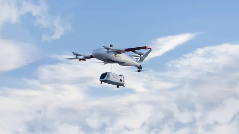 A Zipline Platform 2 aircraft in flight, lowering its delivery droid on a tether