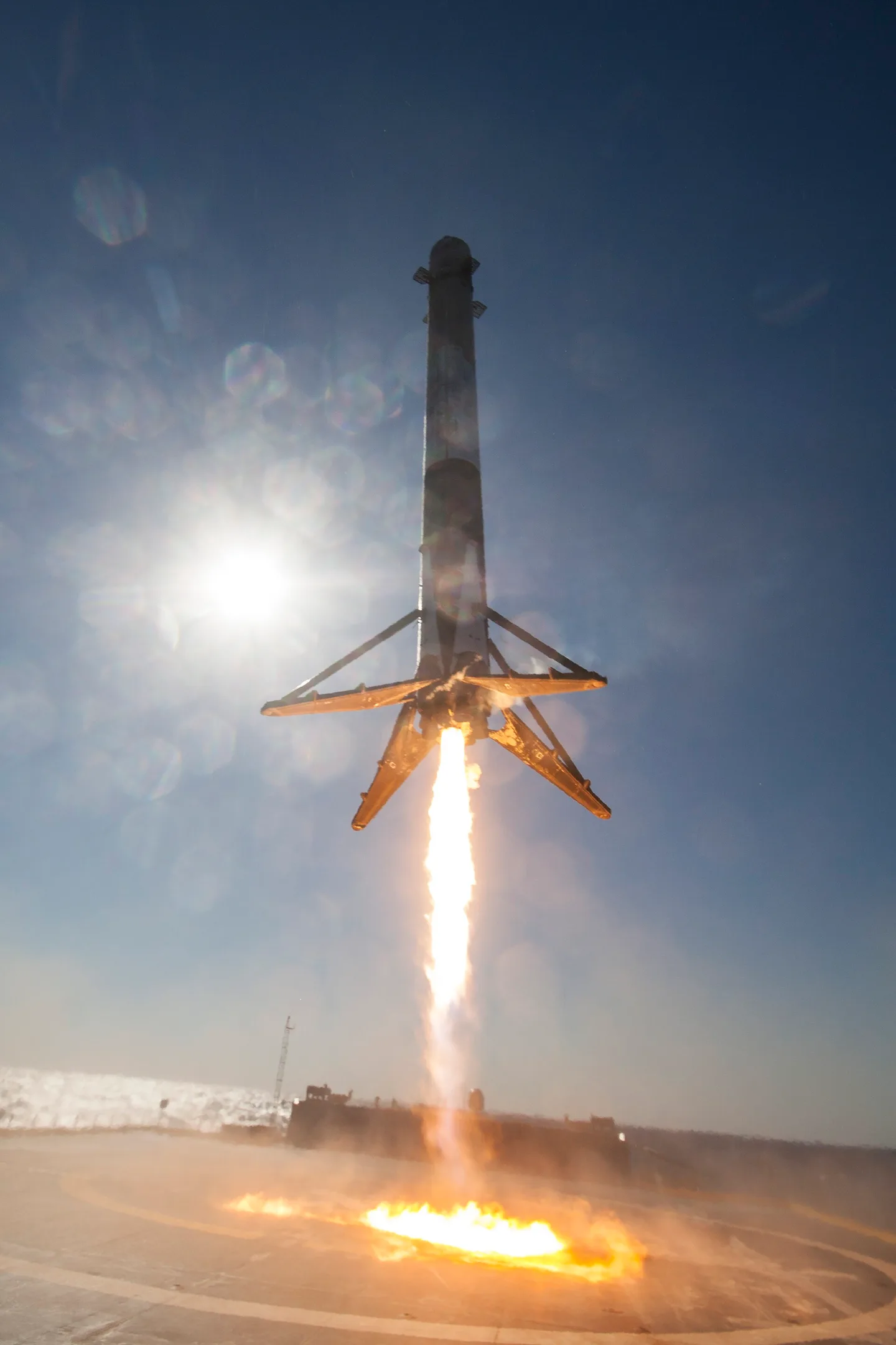 Falcon 9 first stage in its landing burn during the CRS-8 recovery, legs deployed, descending to the droneship