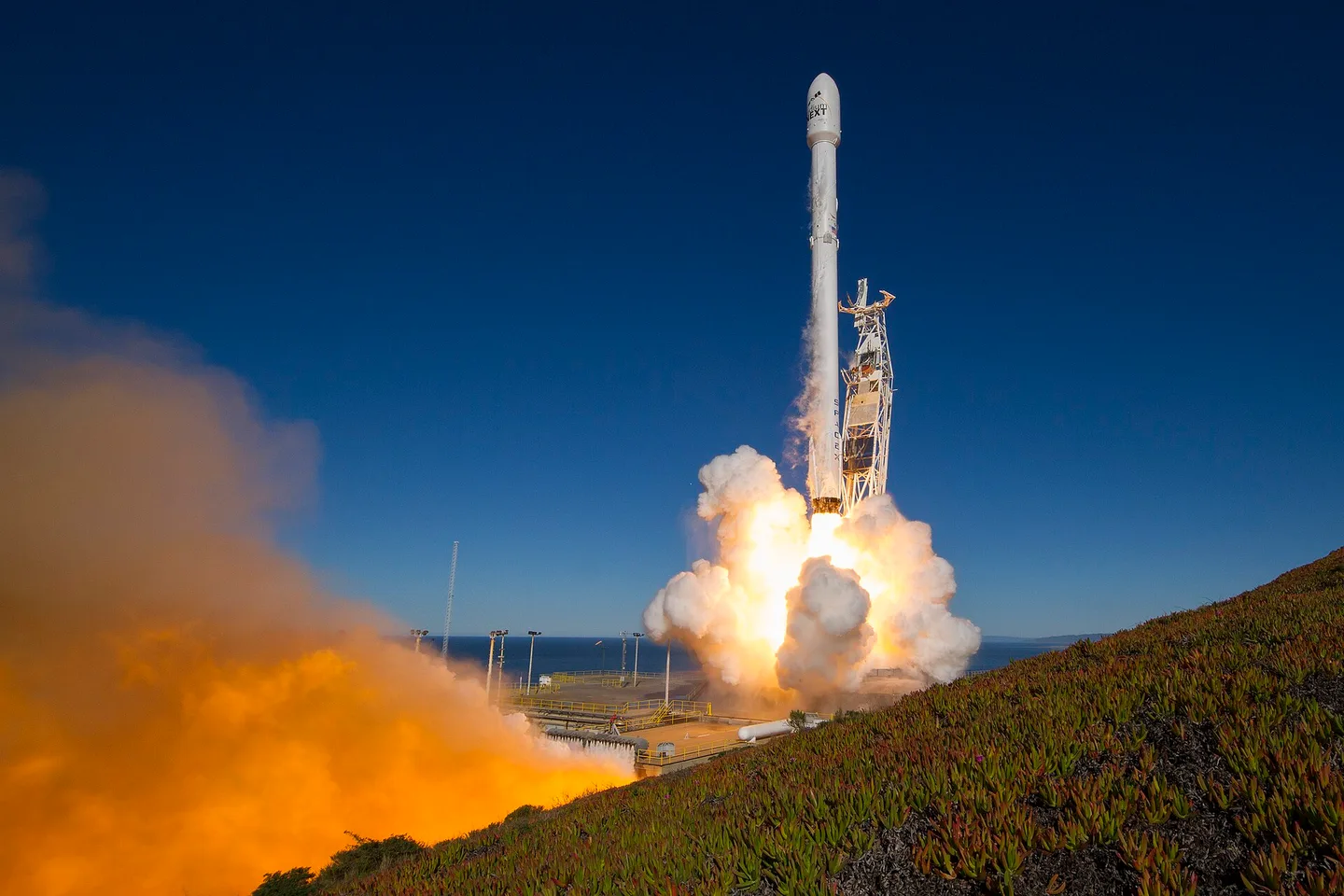 Falcon 9 lifting off, exhaust lighting the pad