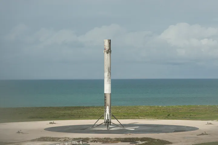 The CRS-11 first stage standing at Landing Zone 1 after touchdown