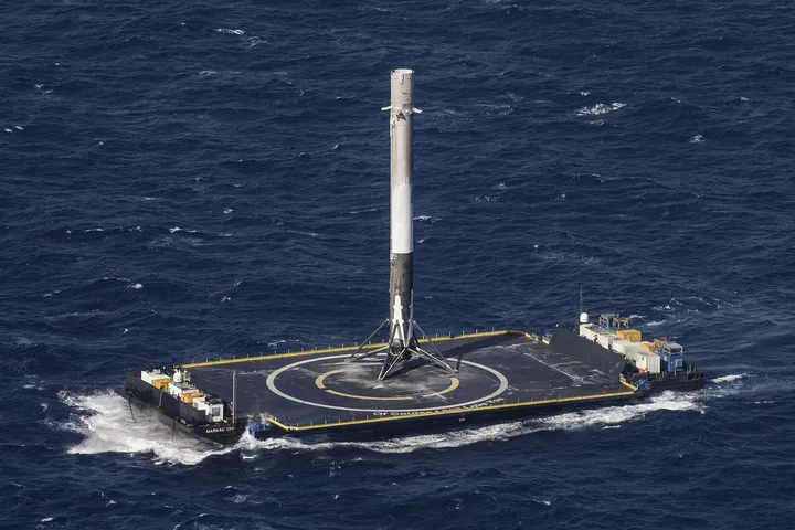 Recovered Falcon 9 first stage standing on the droneship deck
