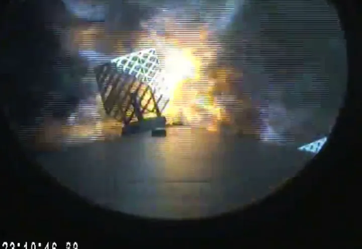 Grid fins deployed on the Falcon 9 first stage during re-entry, a frame from the DSCOVR launch webcast