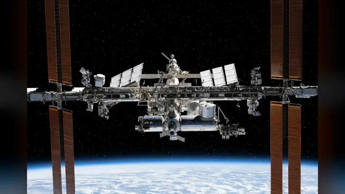 The International Space Station photographed from a departing Crew Dragon in November 2021, restyled onto a dark starfield.
